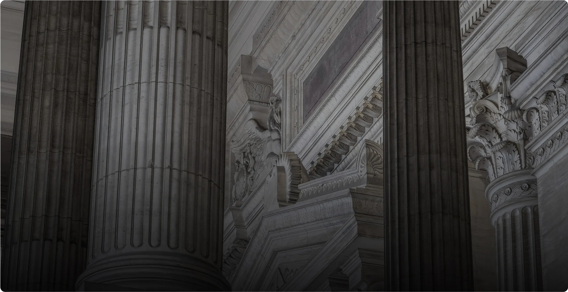 Against a dark background, a post and a wall are visible