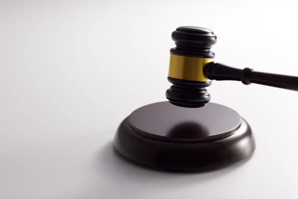 A wooden gavel on a white background.